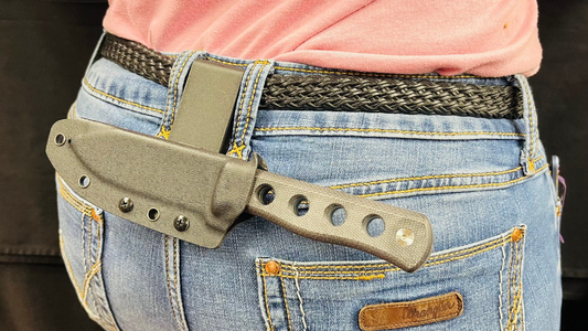 A QSP canary fixed blade knife being carried in the horizontal position.