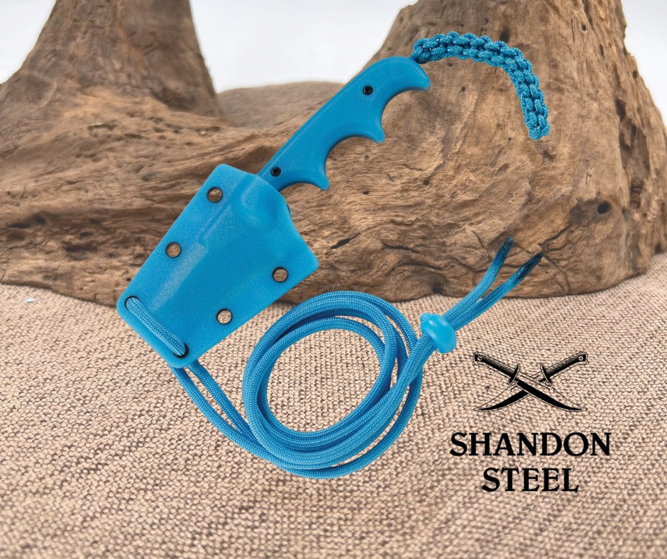 Blue knife sheath with a rope on a textured surface, featuring the Shandon Steel logo.