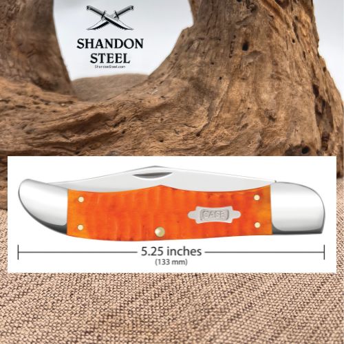 An orange textured handle pocket knife shown in a product graphic with a white measurement label indicating 5.25 inches (133 mm) and a Shaneon Steel logo at the top, set against a rustic wood and burlap background.