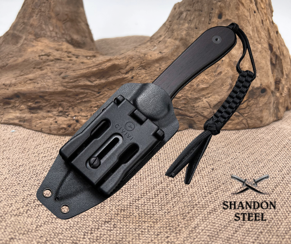 Black knife sheath with a tassel on a textured surface, featuring the Shandon Steel logo.