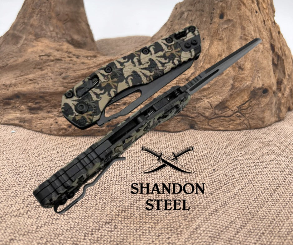 Camouflage-patterned knife with 'Shandon Steel' logo on a textured surface