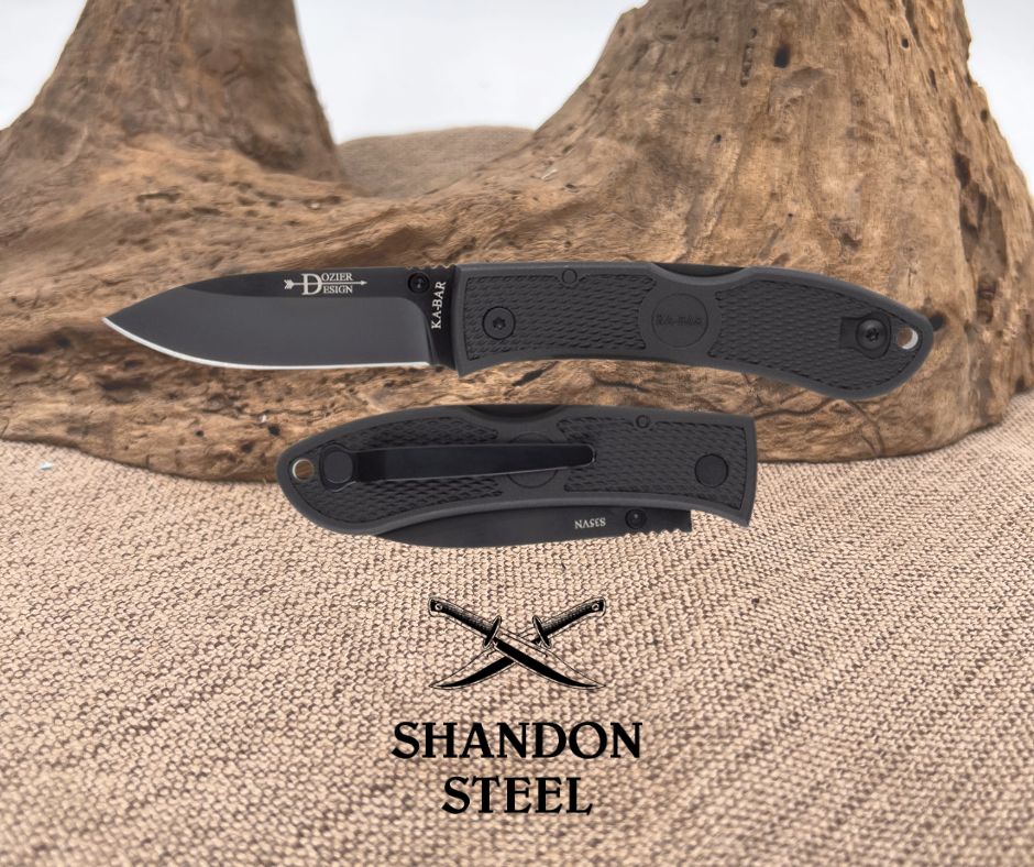 Folding knife with black blade and handle on a textured surface with 'Shandon Steel' branding.