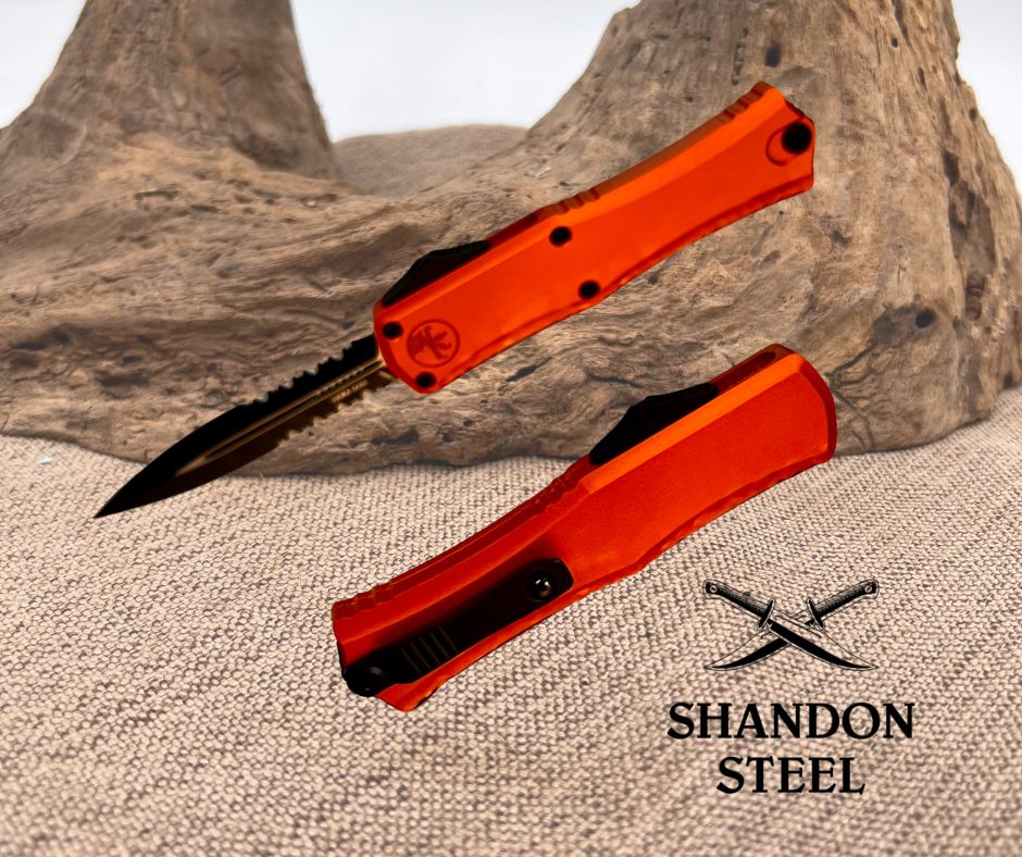 Orange folding knife with a black blade on a textured surface, featuring the Shandon Steel logo.