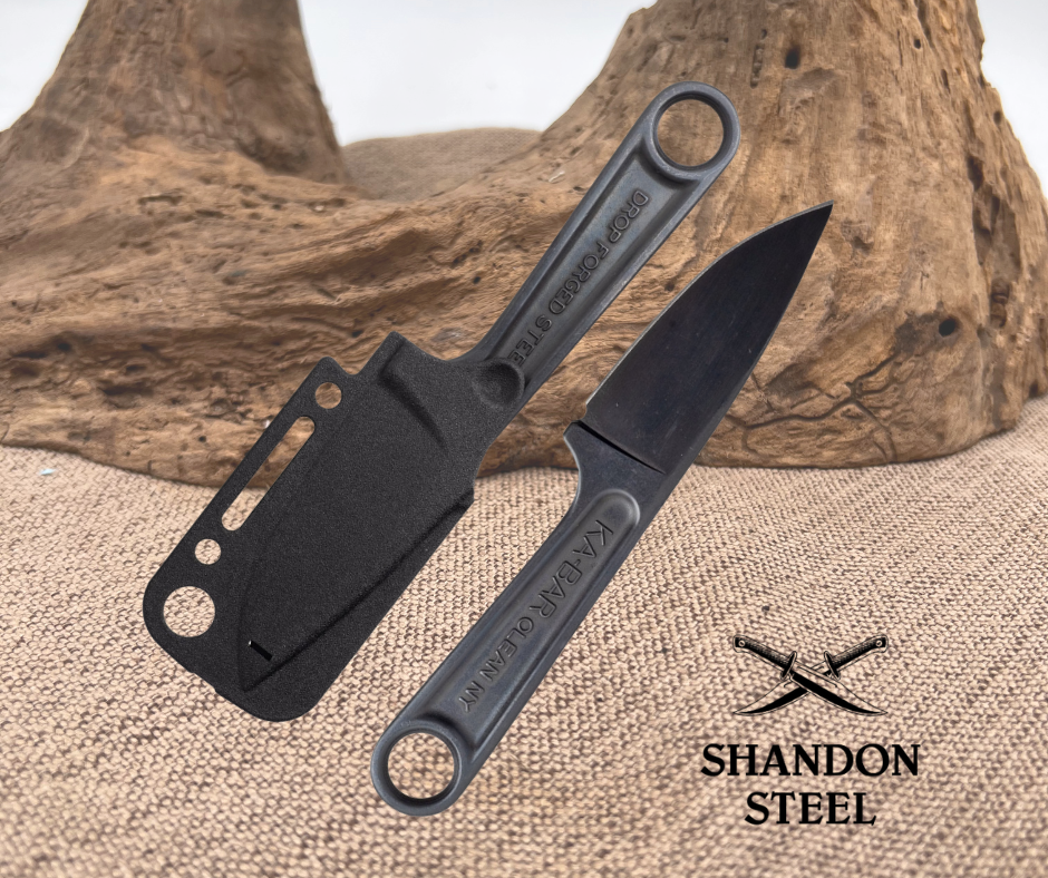 Black knife with sheath on a textured surface, Shandon Steel logo visible