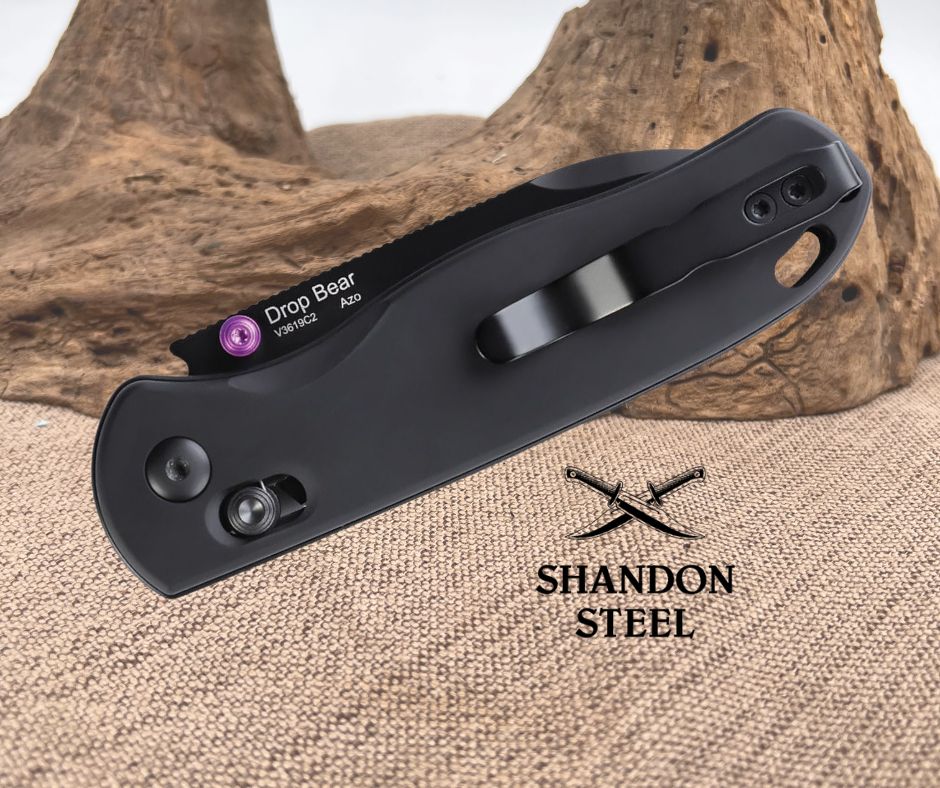 Black folding knife with 'Shandon Steel' branding on a textured surface