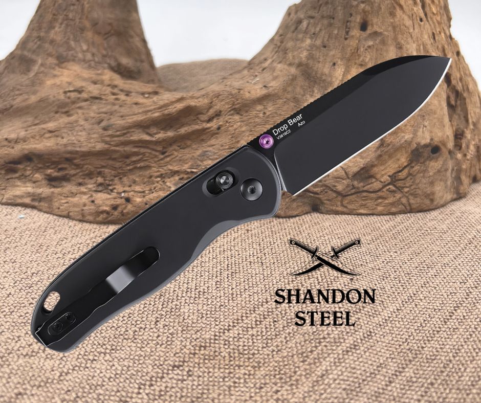Black folding knife with 'Shandon Steel' branding on a textured surface