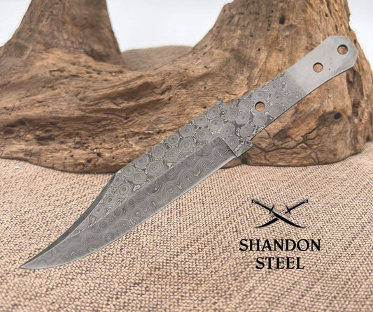 A Damascus steel Bowie knife blade with full tang design, displayed on a textured background with the brand 'Shandon Steel' visible.