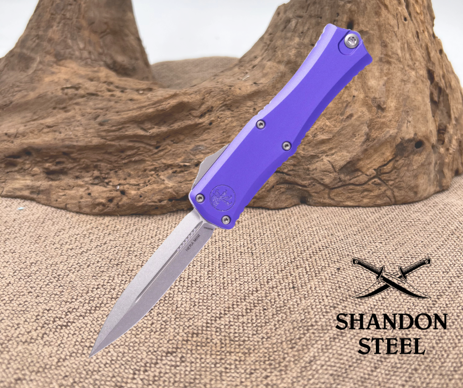 Folding knife with purple handle on a textured surface, Shandon Steel branding visible