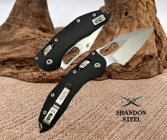 Two folding knives on a wooden surface with 'Shandon Steel' branding.