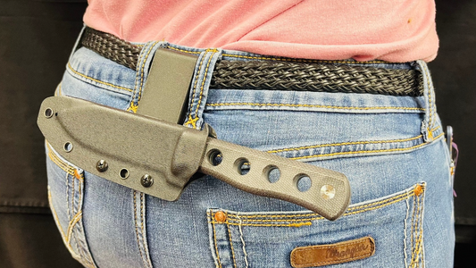 A QSP canary fixed blade knife being carried in the horizontal position. 