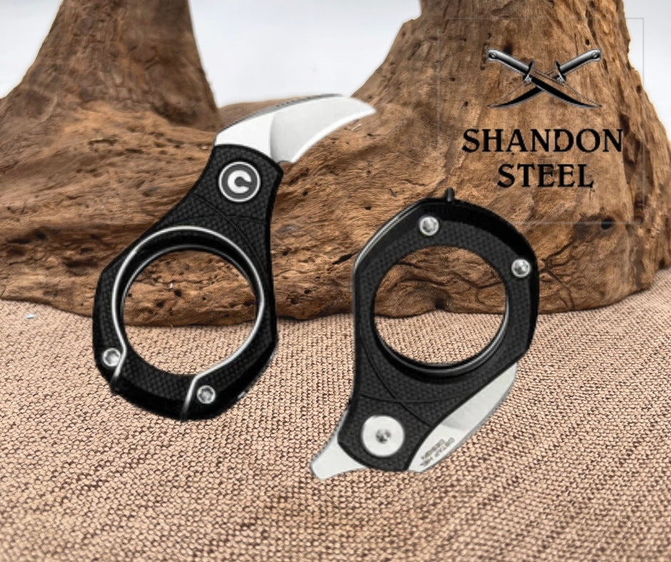 Two black-handled knives on a textured surface with 'Shandon Steel' branding.