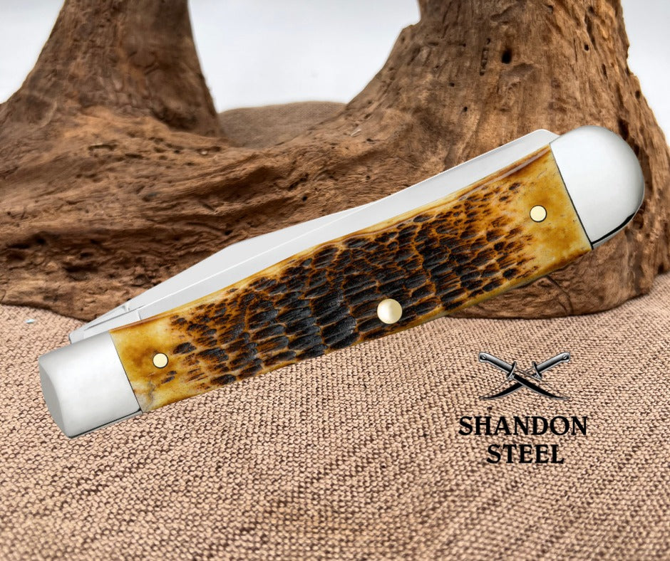 Case XX Rogers Jigged Burnt Amber Bone CS Trapper 51390