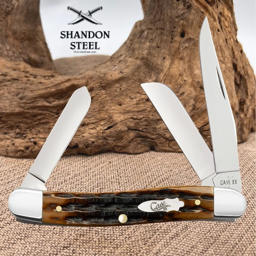 A Shandon Steel Case XX folding pocket knife with two open silver blades and a brown and black tortoiseshell handle, displayed against a rustic wood and burlap background.