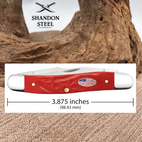 A red-handled pocket knife shown on a white measurement panel with printed text indicating 3.875 inches (98.