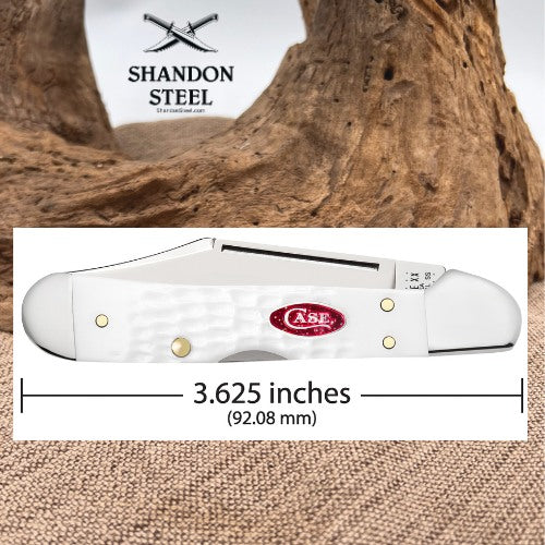 A white Case folding pocket knife shown on a white background with a wood-driftwood backdrop and measurement line indicating a length of 3.625 inches (92.