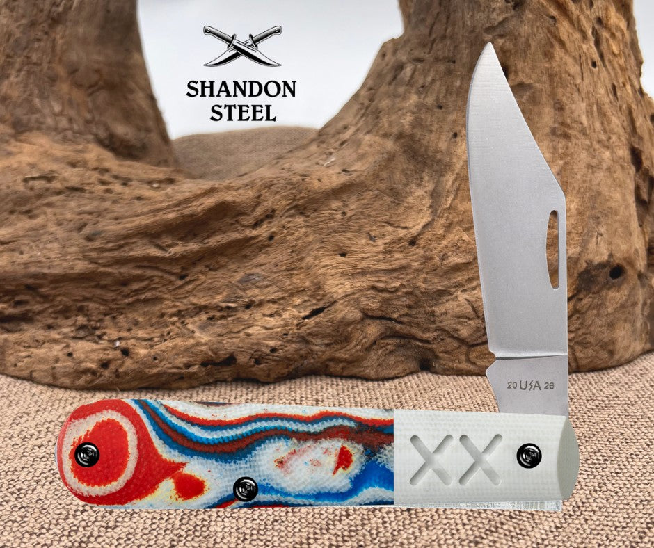 Foldable knife with colorful handle and Shandon Steel logo in the background