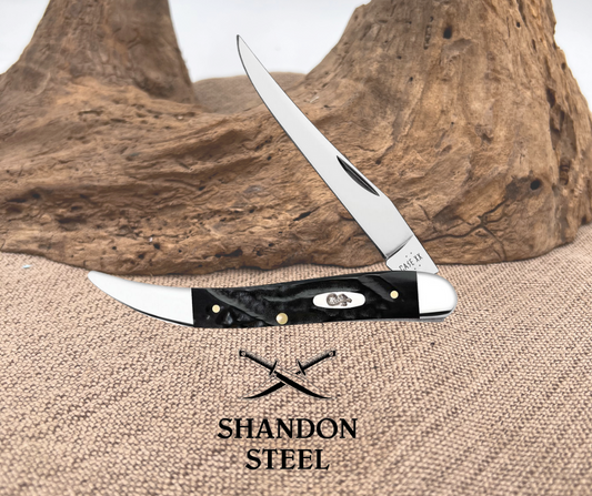 A Case XX toothpick knife with a rough black synthetic handle and a mirror finish stainless steel blade, closed position, displayed on a textured background.