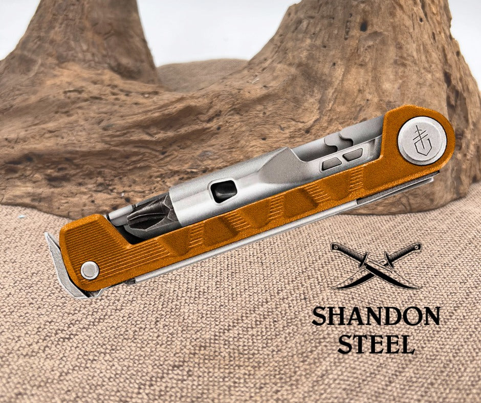 Multitool with wooden handle and metallic components on a textured surface with 'Shandon Steel' branding.