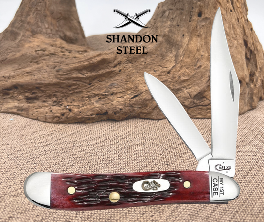 Case knife with red handle and silver blade on a wooden background, featuring Shandon Steel branding.