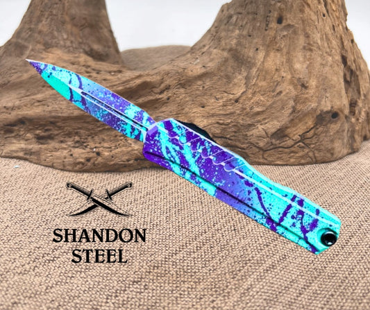 Blue and purple patterned knife on a wooden background with Shandon Steel branding.