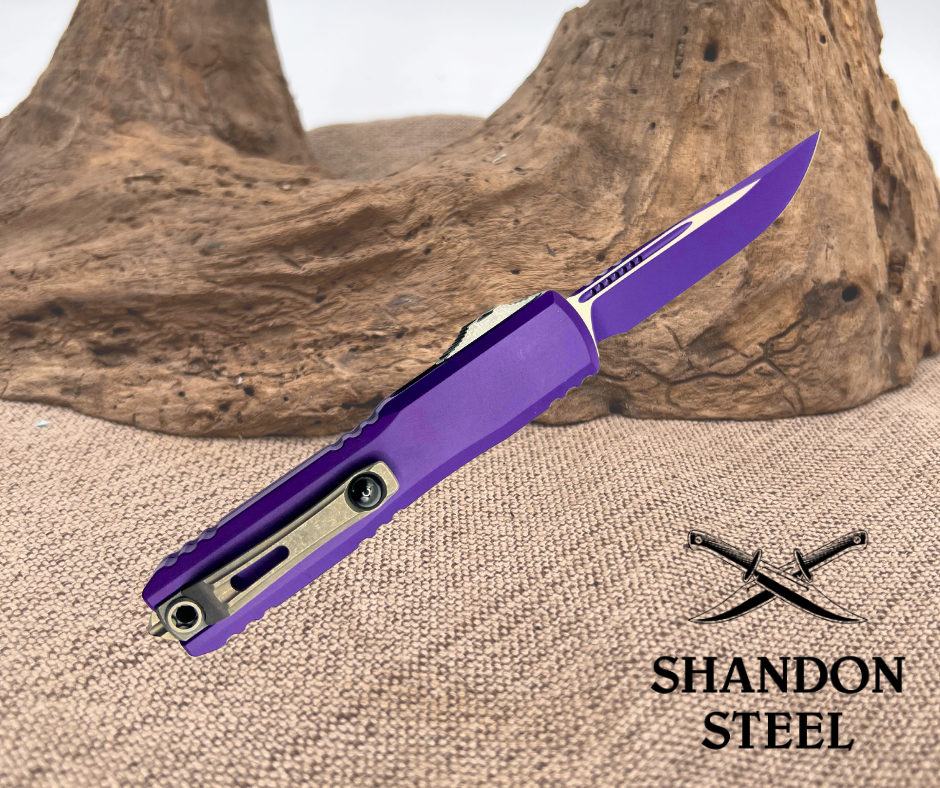 Purple folding knife with 'Shandon Steel' logo on a textured surface
