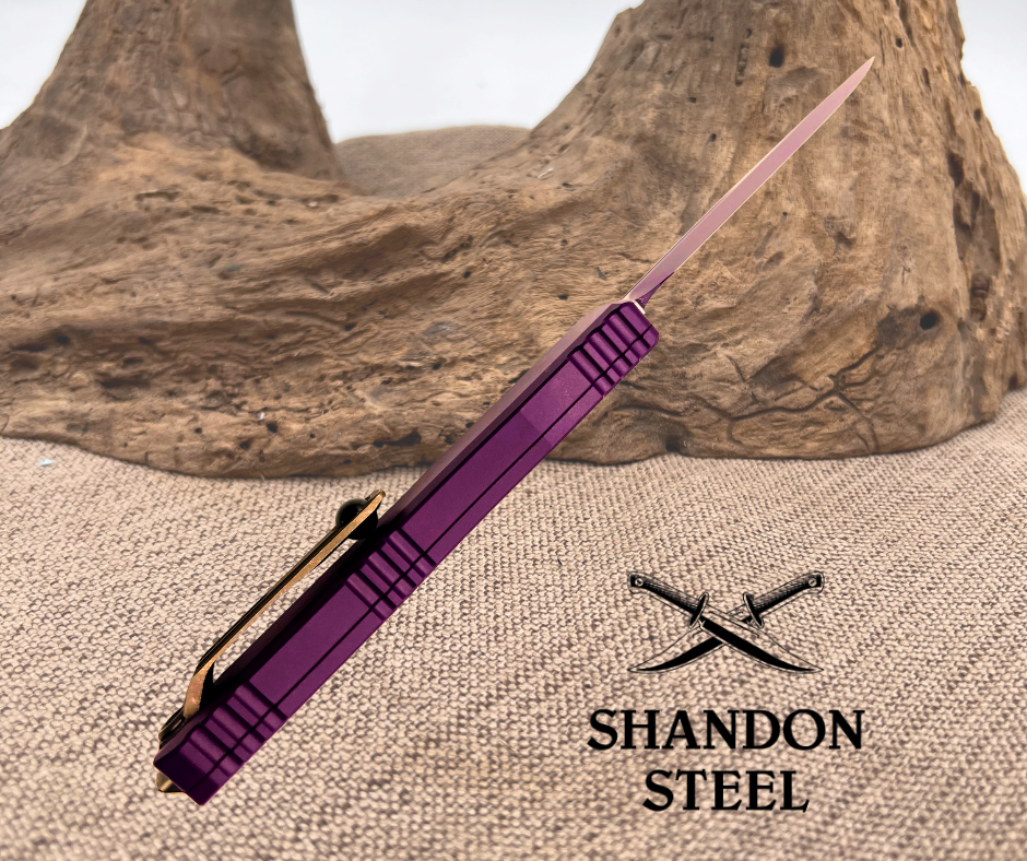 Purple folding knife with Shandon Steel logo on a textured surface