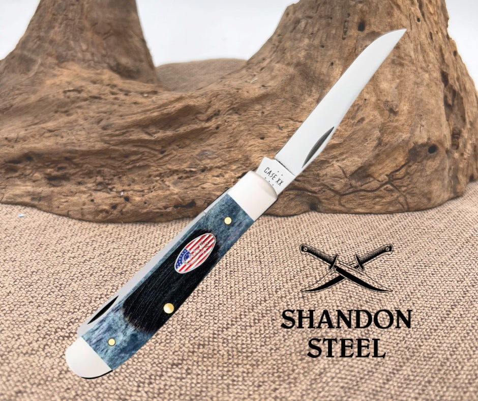 Fork knife with wooden handle and American flag emblem on a textured surface, Shandon Steel branding visible.