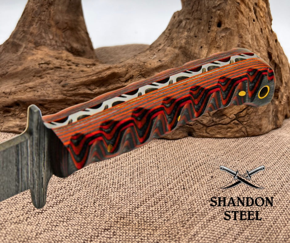 Decorative knife handle with wavy pattern on a textured surface, Shandon Steel logo visible