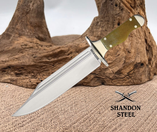 Knife with a green handle on a textured surface, branded 'Shandon Steel'.